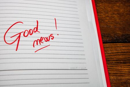 Good news, handwriting text on page of office agenda. Copy space.の写真素材