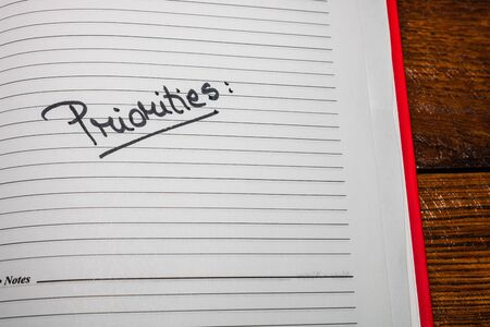 Priorities, handwriting text on page of office agenda. Copy space.の写真素材