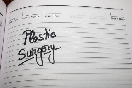 Plastic surgery, handwriting text on page of office agenda. Copy space.の写真素材