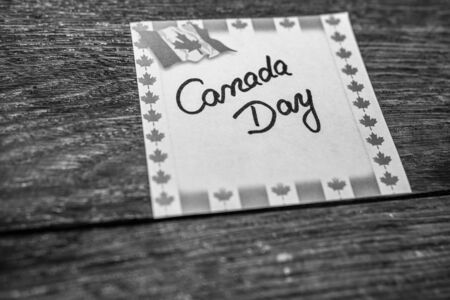 Canada day, handwriting text on memo post reminder with Canada flag.のeditorial素材