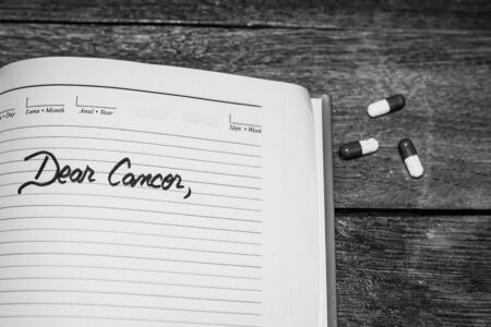Dear Cancer, handwriting text on page of personal agenda. Letter for cancer disease. Copy space.のeditorial素材