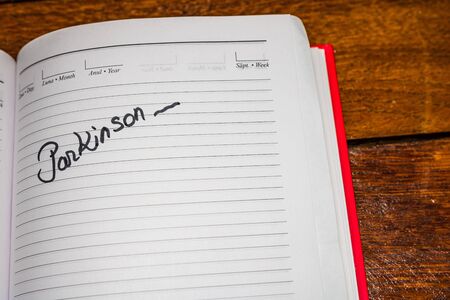 Parkinson, handwriting text on page of office agenda. Copy space.のeditorial素材