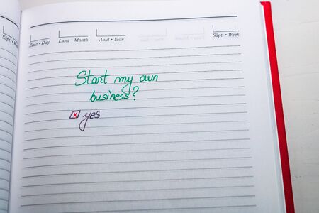 Start my own business and check mark, handwriting text on page of office agenda. Copy space.の写真素材