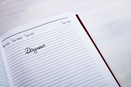 Diagnosis, handwriting text on page of office agenda. Copy space.の写真素材
