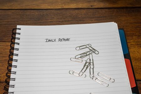 Daily report, handwriting text on page of office agenda, office spiral notebook. Copy space.の写真素材