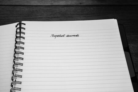 Important documents, handwriting text on page of office agenda, office spiral notebook. Copy space.の写真素材