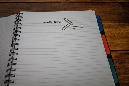 Notary public, handwriting text on page of office agenda, office spiral notebook. Copy space.の写真素材
