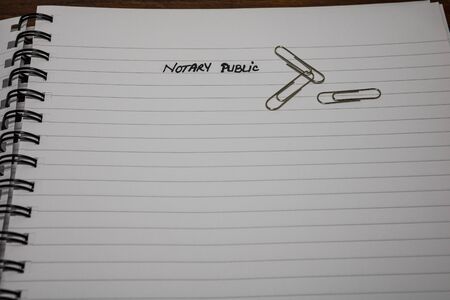 Notary public, handwriting text on page of office agenda, office spiral notebook. Copy space.の写真素材