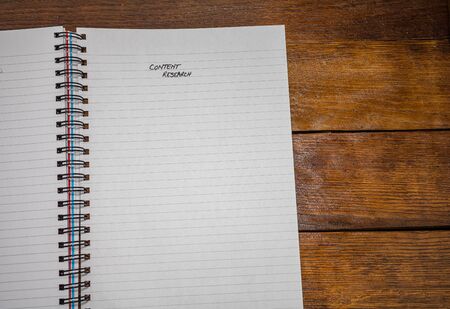 Content research, handwriting text on page of office agenda, office spiral notebook. Copy space.の写真素材