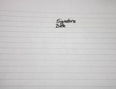 Signature and date, handwriting text on page of office agenda, office spiral notebook. Copy space.の写真素材