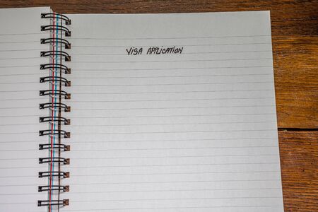 Visa application, handwriting text on page of office agenda, office spiral notebook. Copy space.の写真素材