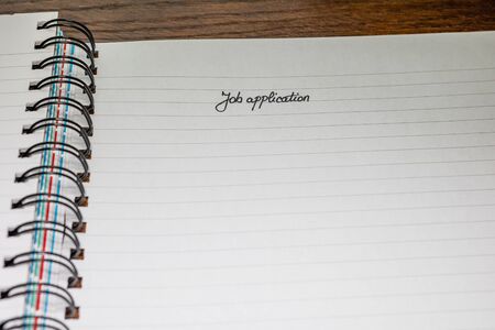 Job application, handwriting text on page of office agenda, office spiral notebook. Copy space.の写真素材