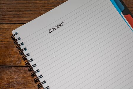 Contract, handwriting text on page of office agenda, office spiral notebook. Copy space.の写真素材