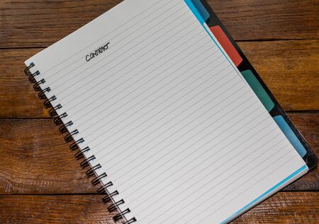 Contract, handwriting text on page of office agenda, office spiral notebook. Copy space.の写真素材