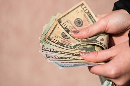 Woman counting money, counting dollars close up.の写真素材