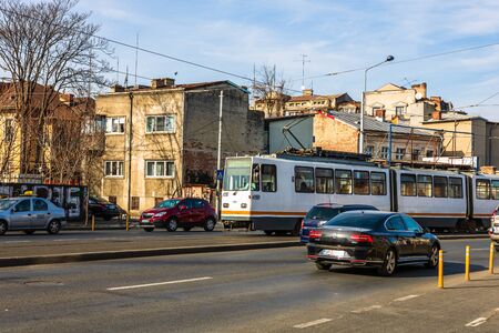 Car traffic at rush hour in downtown area. Tram in traffic. Bucharest, Romania, 2020.のeditorial素材
