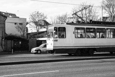 Car traffic at rush hour in downtown area. Tram in traffic. Bucharest, Romania, 2020.のeditorial素材