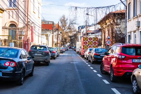Cars parked along the street. Bucharest, Romania, 2020.のeditorial素材