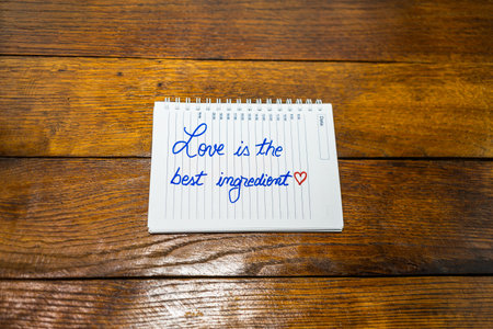 Love is the best ingredient, writing love text on paper, lovely message. Text on spiral agenda....