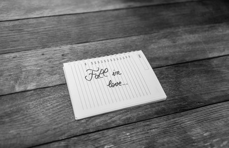 Fall in love, writing love text on paper, lovely message. Text on spiral agenda. Romantic, love...