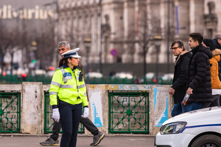Police agent, Romanian Traffic Police (Politia Rutiera) directing traffic during the morning rush hour in downtown Bucharest, Romania, 2020のeditorial素材