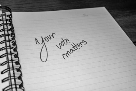 Your vote matters, handwriting  text on paper, political message. Political text on office agenda. Concept of democracy, voting, politics. Copy space.の写真素材