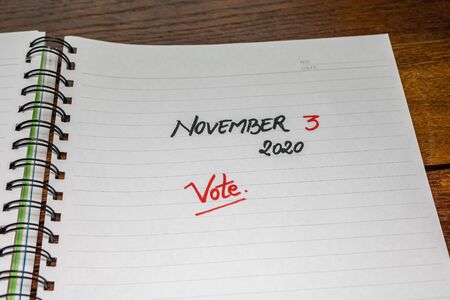 November 3 2020, vote (USA presidential election) handwriting  text on paper, political message. Political text on office agenda. Concept of democracy, voting, politics. Copy space.の写真素材