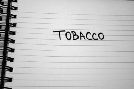Tobacco handwriting  text on paper, on office agenda. Copy space.の写真素材