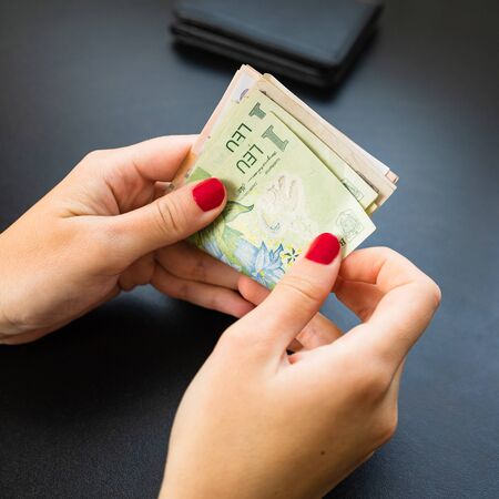 Hands counting money, counting LEI close upのeditorial素材