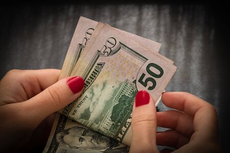 Woman counting money, counting dollars close upのeditorial素材