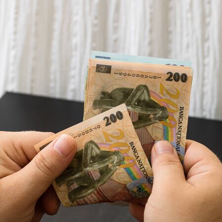 Hands counting money, counting LEI close upのeditorial素材