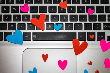 Heart shaped paper cut out on keyboard, love message and Valentine`s day concept.のeditorial素材