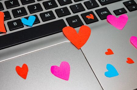 Heart shaped paper cut out on keyboard, love message and Valentine`s day concept.のeditorial素材