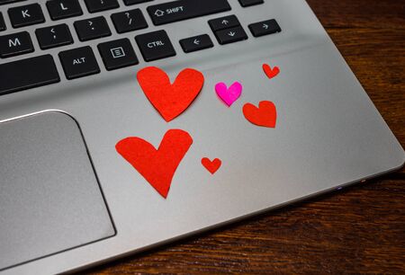 Heart shaped paper cut out on keyboard, love message and Valentine`s day concept.のeditorial素材