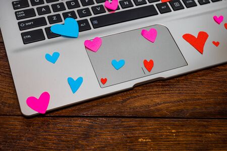 Heart shaped paper cut out on keyboard, love message and Valentine`s day concept.のeditorial素材