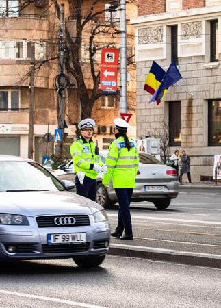 Police agent, Romanian Traffic Police (Politia Rutiera) directing traffic during the morning rush hour in downtown Bucharest, Romania, 2020のeditorial素材