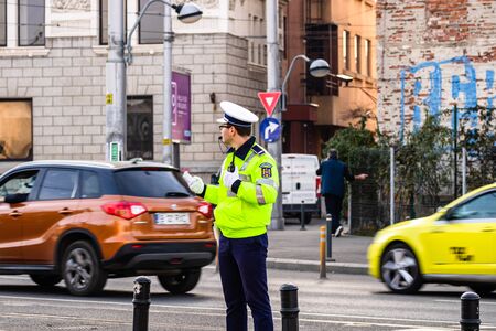 Police agent, Romanian Traffic Police (Politia Rutiera) directing traffic during the morning rush hour in downtown Bucharest, Romania, 2020のeditorial素材