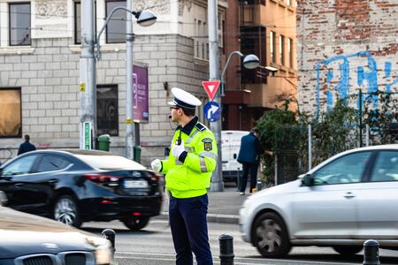 Police agent, Romanian Traffic Police (Politia Rutiera) directing traffic during the morning rush hour in downtown Bucharest, Romania, 2020のeditorial素材