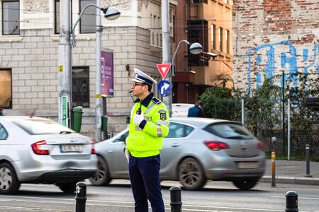 Police agent, Romanian Traffic Police (Politia Rutiera) directing traffic during the morning rush hour in downtown Bucharest, Romania, 2020のeditorial素材