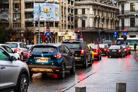 Car traffic at rush hour on the main boulevard in Bucharest downtown. Rainy morning, rainy evening during winter in Bucharest, Romania, 2020のeditorial素材