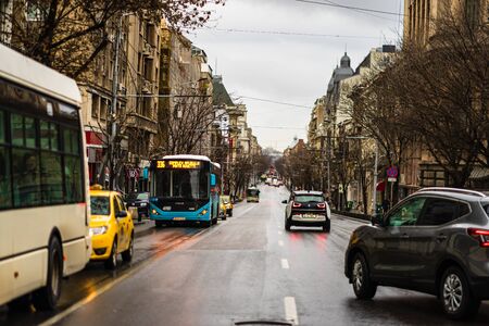 Car traffic at rush hour on the main boulevard in Bucharest downtown. Rainy morning, rainy evening during winter in Bucharest, Romania, 2020のeditorial素材