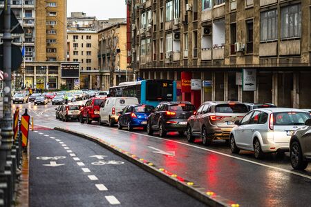 Car traffic at rush hour on the main boulevard in Bucharest downtown. Rainy morning, rainy evening during winter in Bucharest, Romania, 2020のeditorial素材