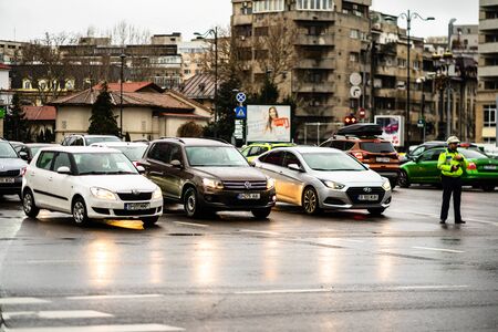 Car traffic at rush hour on the main boulevard in Bucharest downtown. Rainy morning, rainy evening during winter in Bucharest, Romania, 2020のeditorial素材