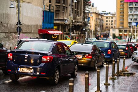 Car traffic at rush hour on the main boulevard in Bucharest downtown. Rainy morning, rainy evening during winter in Bucharest, Romania, 2020のeditorial素材