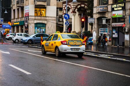 Car traffic at rush hour on the main boulevard in Bucharest downtown. Rainy morning, rainy evening during winter in Bucharest, Romania, 2020のeditorial素材