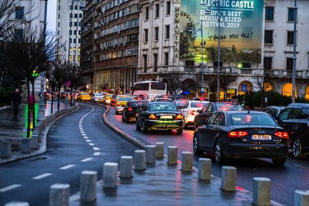 Car traffic at rush hour on the main boulevard in Bucharest downtown. Rainy morning, rainy evening during winter in Bucharest, Romania, 2020のeditorial素材