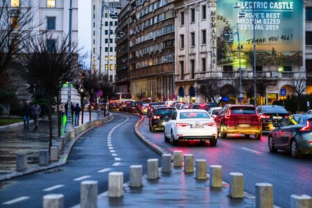 Car traffic at rush hour on the main boulevard in Bucharest downtown. Rainy morning, rainy evening during winter in Bucharest, Romania, 2020のeditorial素材