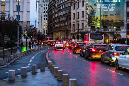 Car traffic at rush hour on the main boulevard in Bucharest downtown. Rainy morning, rainy evening during winter in Bucharest, Romania, 2020のeditorial素材