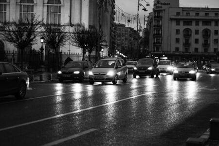 Car traffic at rush hour on the main boulevard in Bucharest downtown. Rainy morning, rainy evening during winter in Bucharest, Romania, 2020のeditorial素材