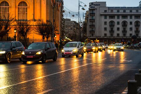 Car traffic at rush hour on the main boulevard in Bucharest downtown. Rainy morning, rainy evening during winter in Bucharest, Romania, 2020のeditorial素材